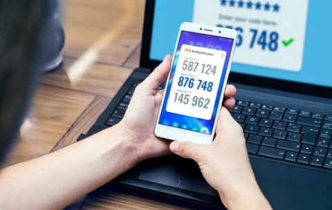 A person holding a phone with numbers on the screen

Description automatically generated